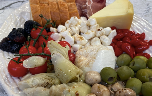 antipasto platter drizzled with homemade balsamic vinaigrette